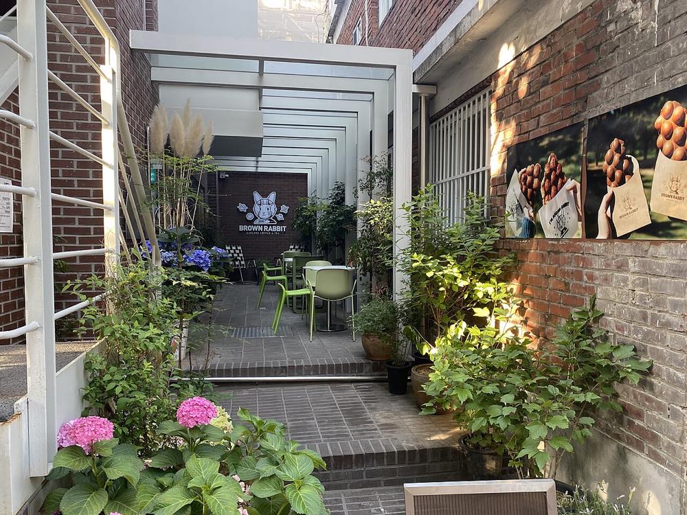 Flower-decorated cafe storefront in Seongsu-dong, Seoul, the neighborhood where BTS RM's sister runs Café Farben