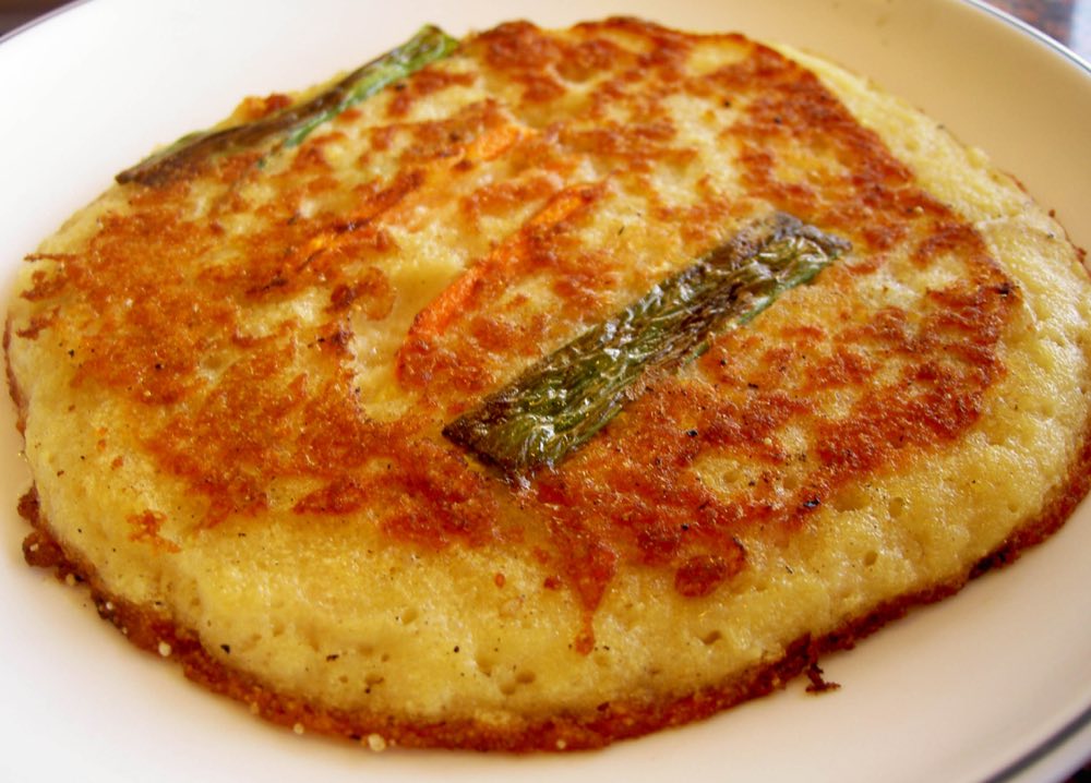 Bindaetteok, crispy Korean mung bean pancakes fried fresh at Gwangjang Market food stalls