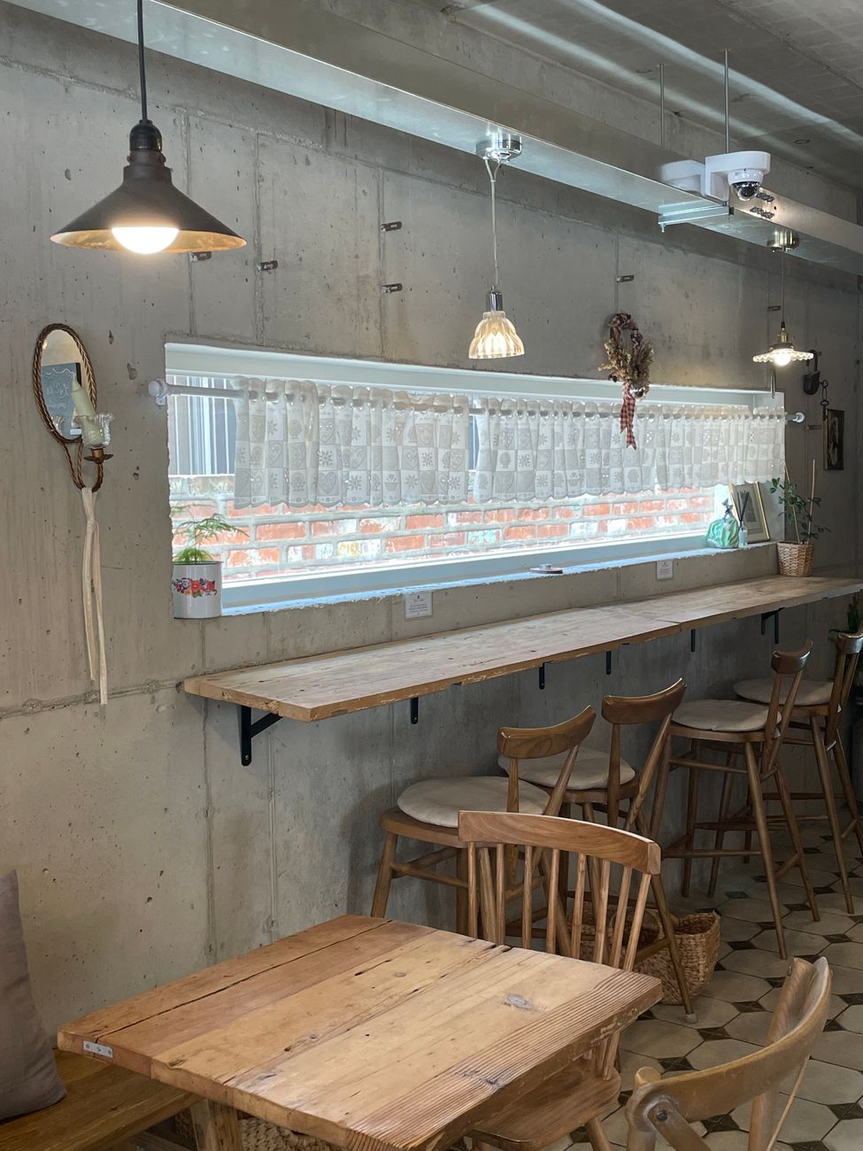 A cozy cafe window seat with coffee and dessert, evoking the relaxed vibe of Kamong cafe run by EXO Kai's family