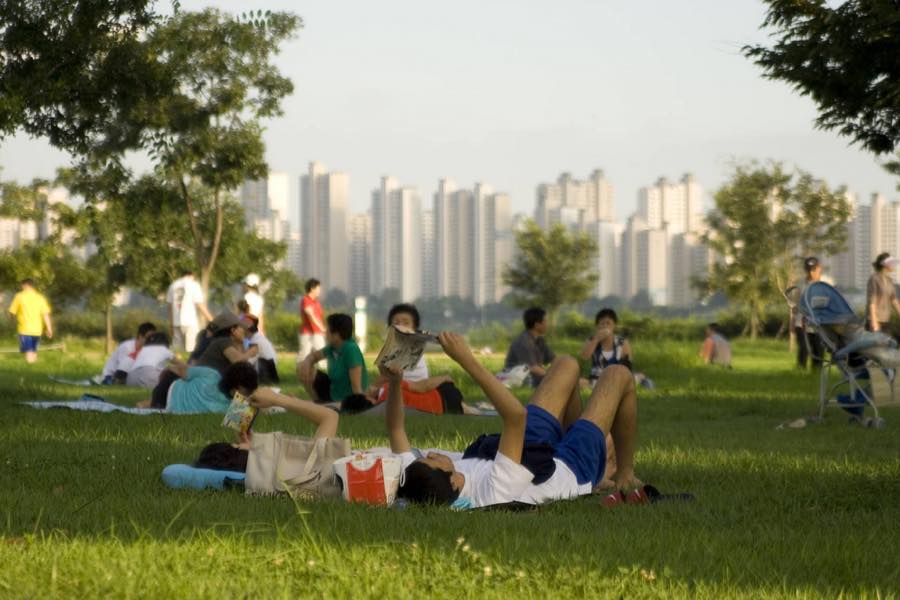 An evening view of Seoul's Han River park, the setting for the circular riverside restaurant featured in Crash Landing on You