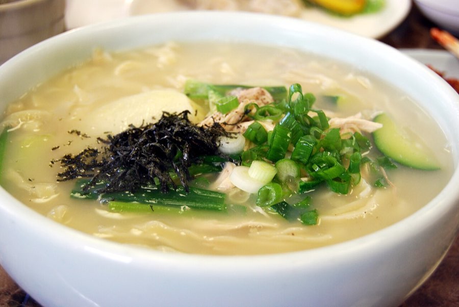 Korean kalguksu knife-cut noodle soup with banchan, representative of the dishes at Hoenamu and Baekhap Kalguksu from Queen of Tears