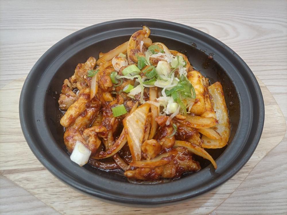 Chuncheon-style dakgalbi, spicy stir-fried chicken cooked on a griddle with cabbage and rice cake
