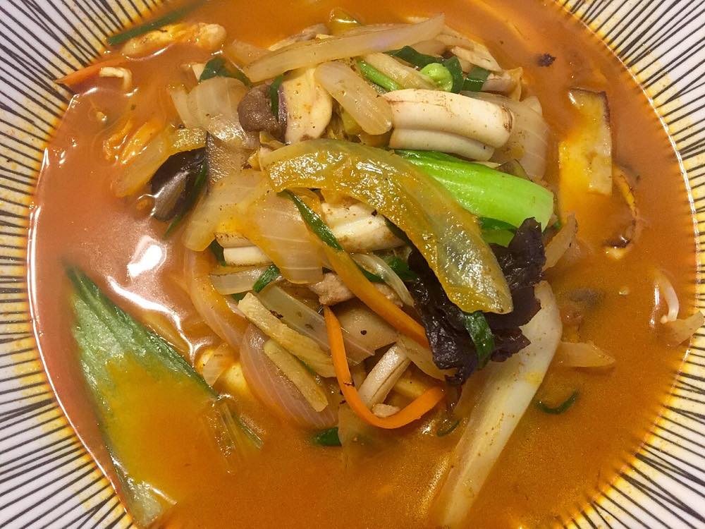Bowl of spicy Korean seafood noodle soup, similar in style to Yeosu's octopus seafood ramen