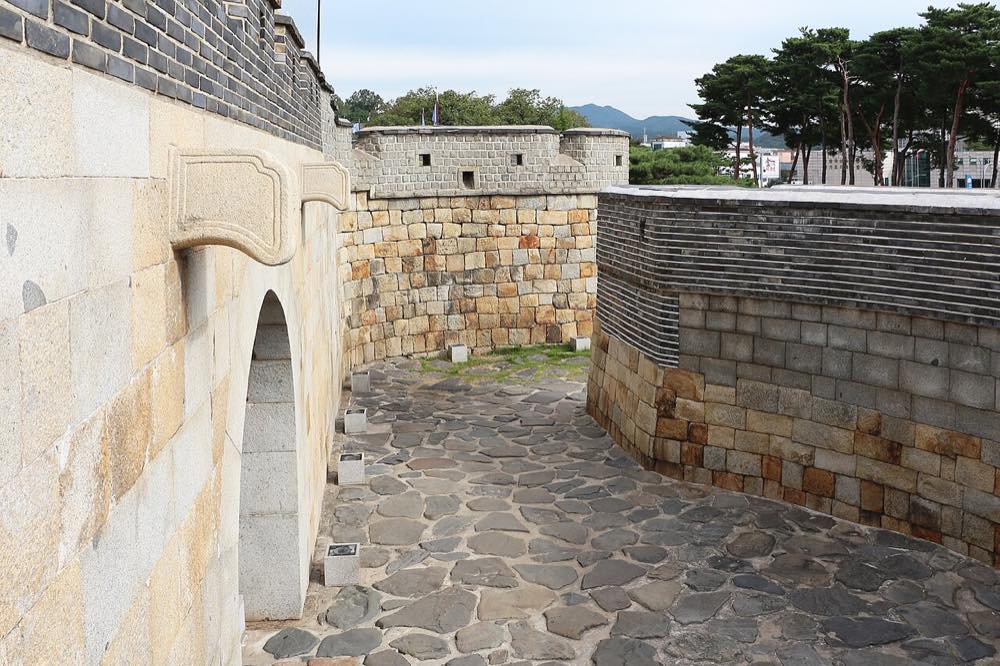 The walls of Hwaseong Fortress in Suwon, part of a full day-trip itinerary that pairs well with a Kajaguruma visit