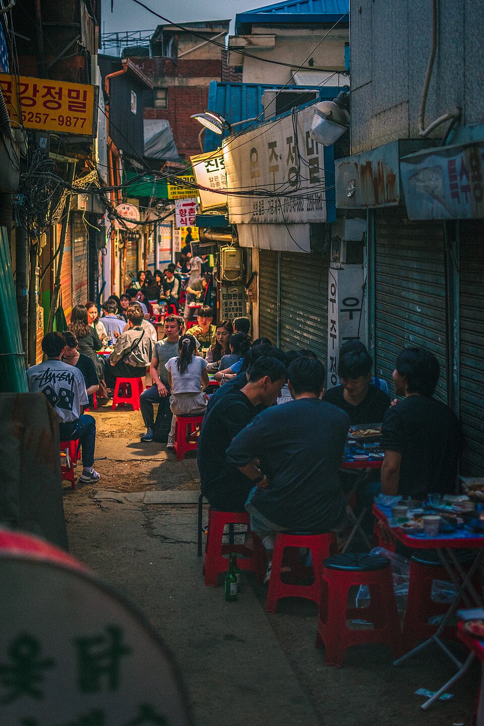 Night view of Euljiro Nogari Alley in Seoul with crowded outdoor beer tables