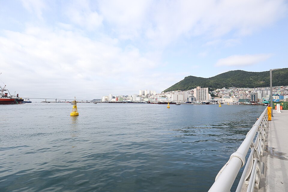 Busan harbor and hillside neighborhoods seen from the waterfront near Jagalchi Market