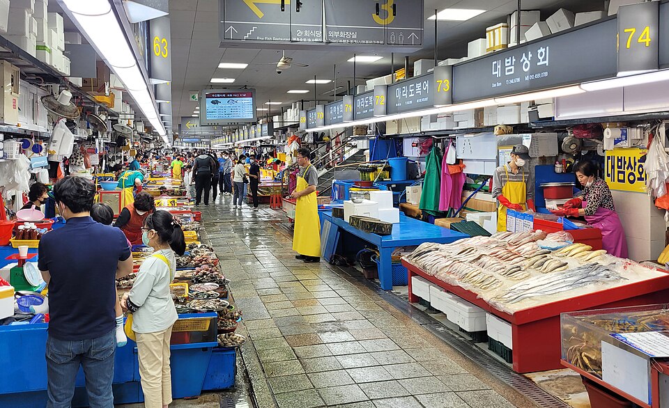 Busan Jagalchi Market indoor seafood stalls with numbered vendor signs