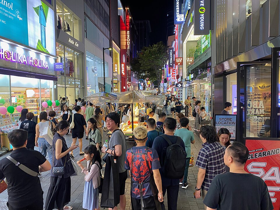 Food stalls and crowds on a Myeongdong street at night in Seoul