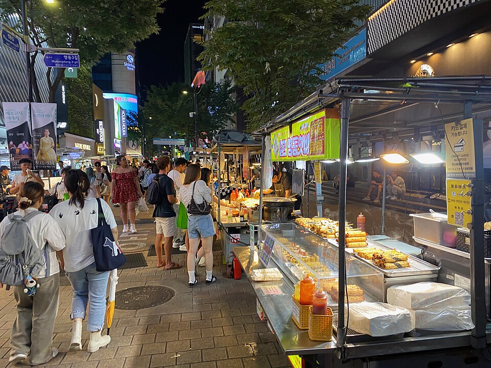Street food cart selling skewers and snacks on a Myeongdong street